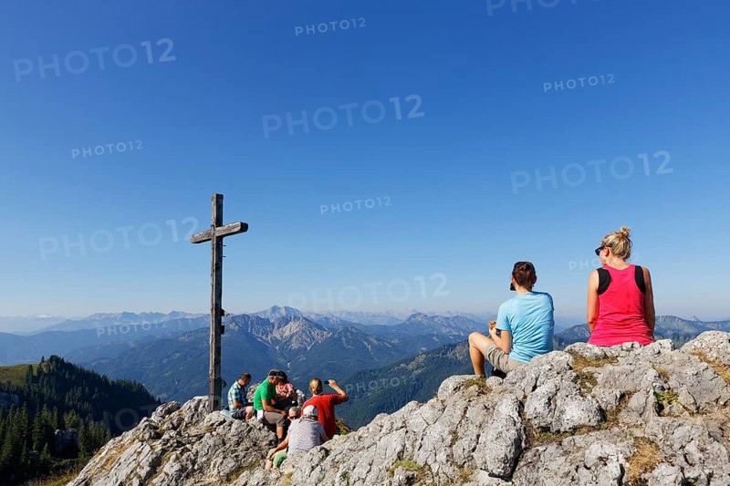Hikers at the summit cross of Mt Taubenstein