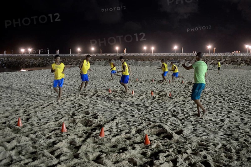 Brazilian youngsters training at night on the beach for the Street Children World Cup 2014