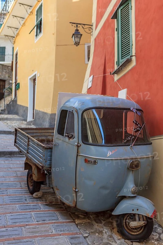 Typical Italian three-wheeled light commercial vehicle parked in an alley