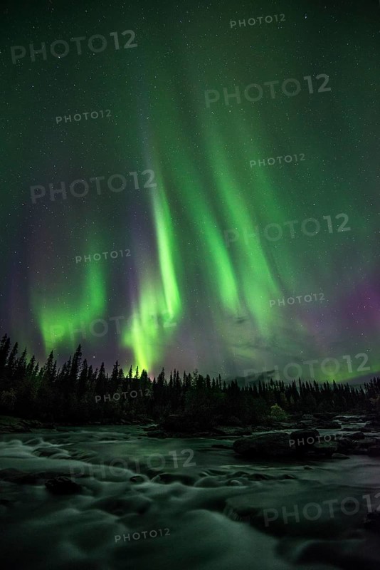 Northern lights or aurora borealis over river
