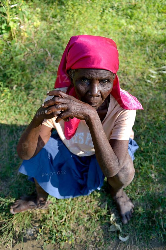 Old woman sitting in the grass