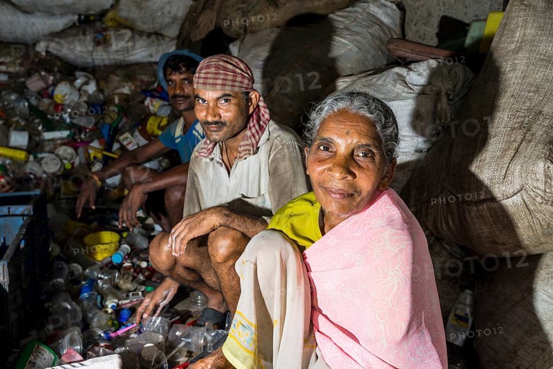 Workers sorting out plastic garbage for recycling