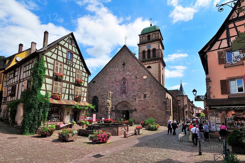 Half-timbered house and fountain in front of the Church of Sainte-Croix on the Rue du General de Gaulle