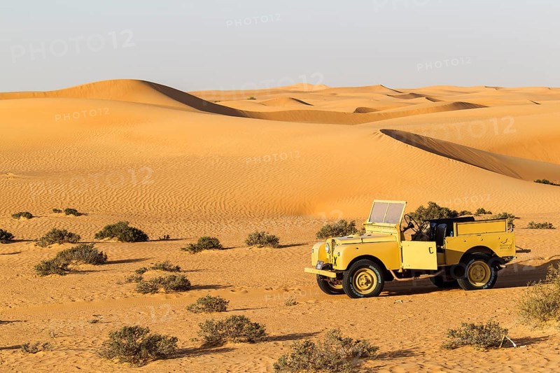 Land rover from the 50s before sand dunes