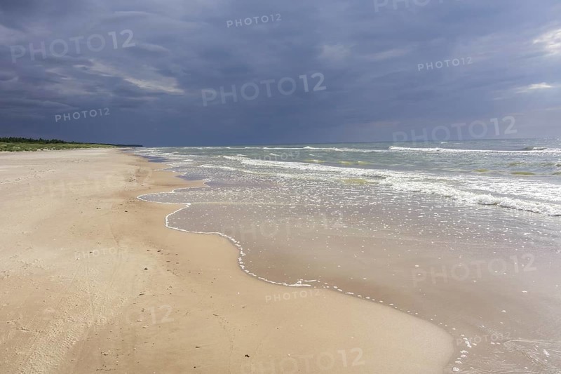 Sandy beach on the Baltic sea with storm clouds