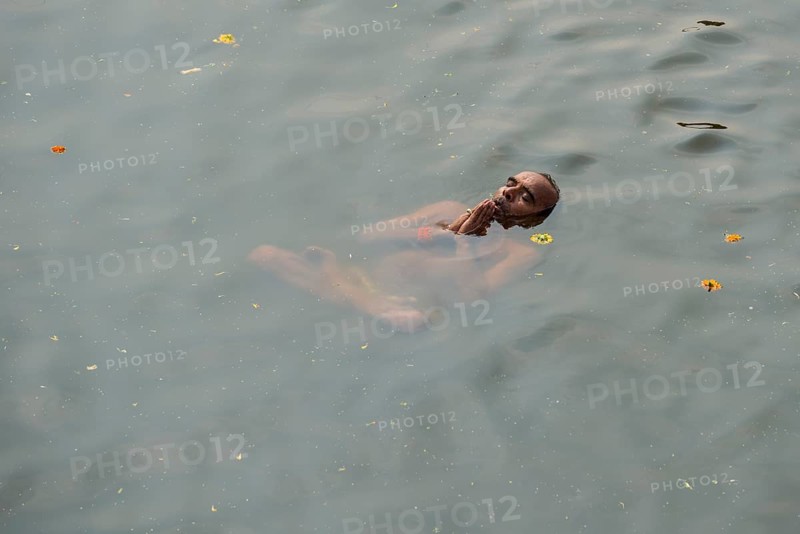 A man is performing padmasana