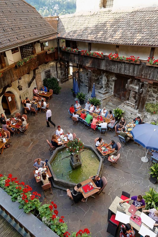Courtyard of Schattenburg Castle with a restaurant