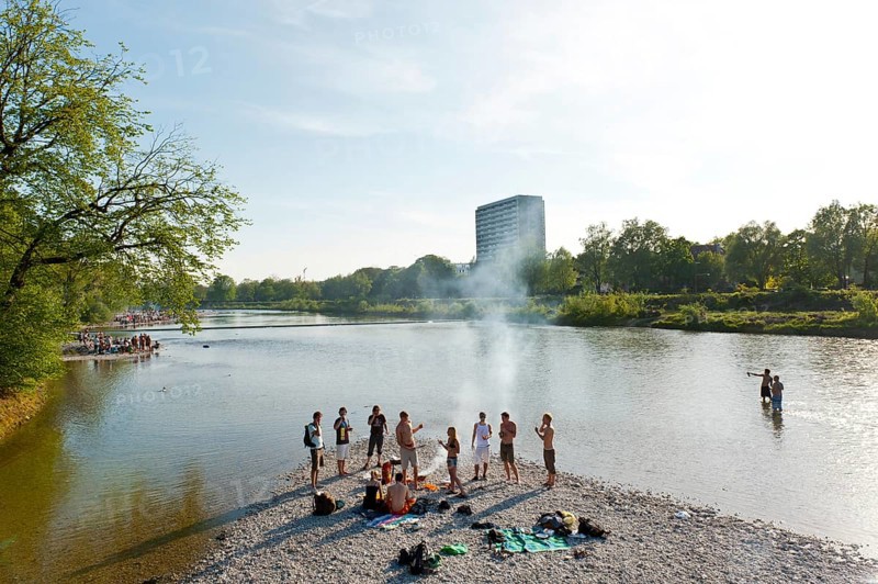 Young people having party on the Isar River in summer