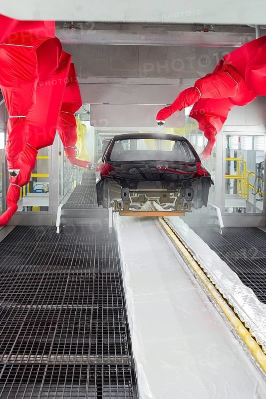 Robots paint a car body in the paint shop at Chrysler's Sterling Heights Assembly Plant