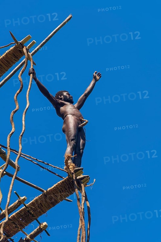 Man jumping from a bamboo tower