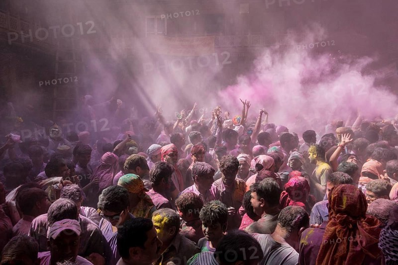 Devotees celebrating and throwing coloured powder