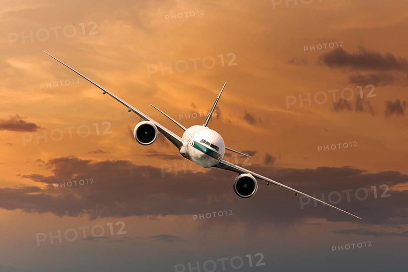 Cathay Pacific Boeing 777-367 ER in flight in the evening light