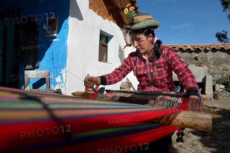 Young woman weaving traditional cloth at the loom