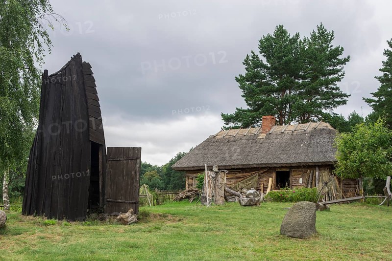 House in an old fishing village and part of a wooden boat that serves as a smokehouse