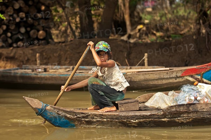 Girl paddling a traditional boat on the Sangker river in Battambang