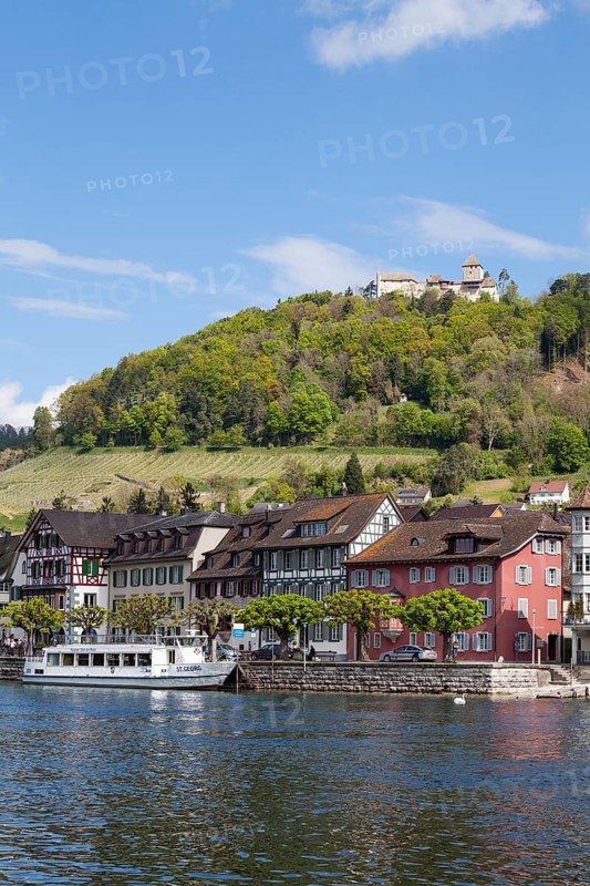 Townscape on the bank of the Rhine River with a boat landing and Burg Hohenklingen Castle