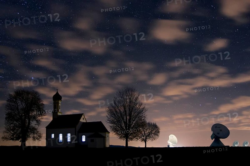 St. Johann Chapel and the satellite earth station in front of the night sky