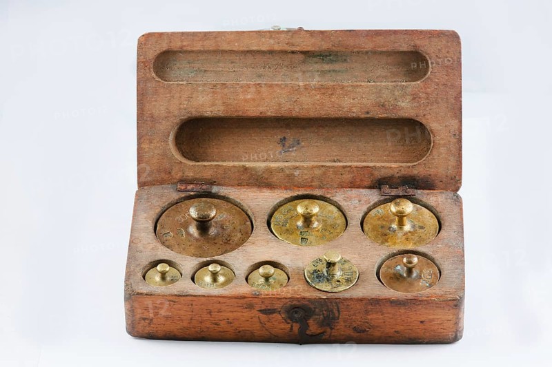 Old brass weights in wooden box with lid
