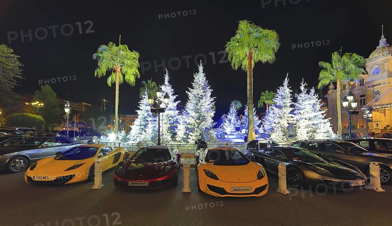 Four McLaren sports car in front of Christmas decoration with white fir trees on the square in front of the Casino de Monte-Carlo