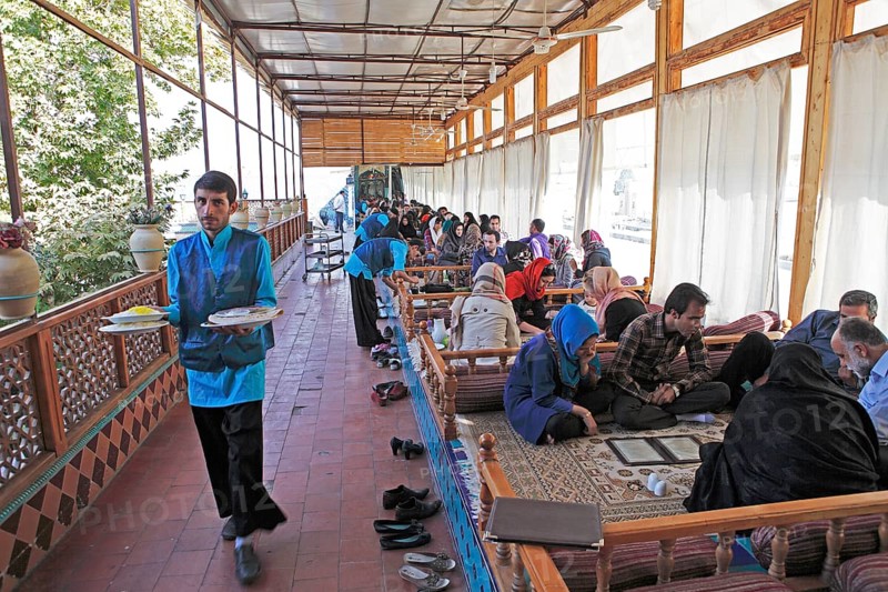 Young Iranians having lunch in a traditional restaurant
