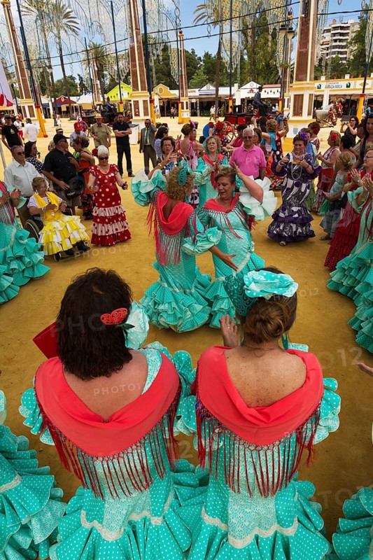 Women wearing gypsy dresses perform traditional Andalusian dances at the Feria del Caballo