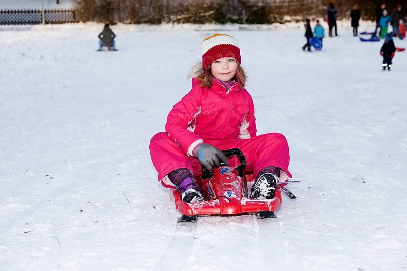 Girl sitting on a sled