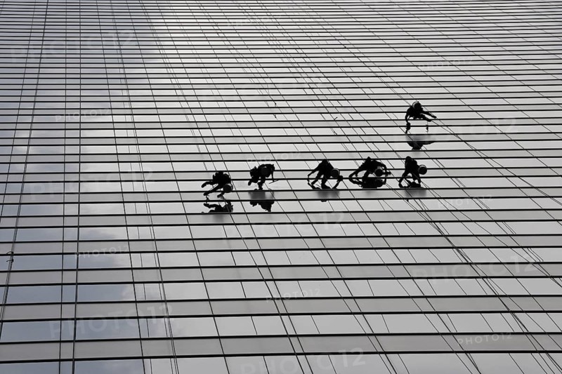 Window cleaners cleaning a glass facade