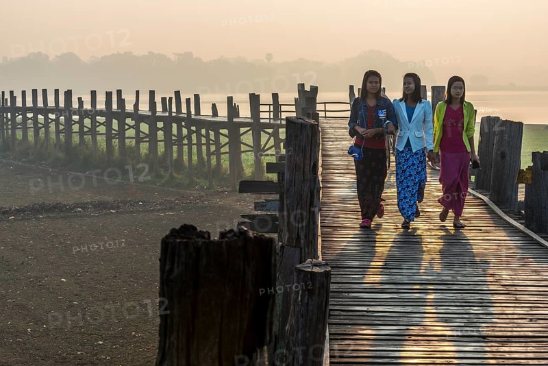 Girls with tanaka on their faces on a teak bridge