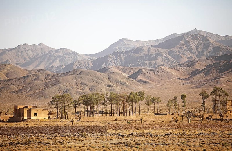 Isolated house and trees in the Kuhrud Mountains