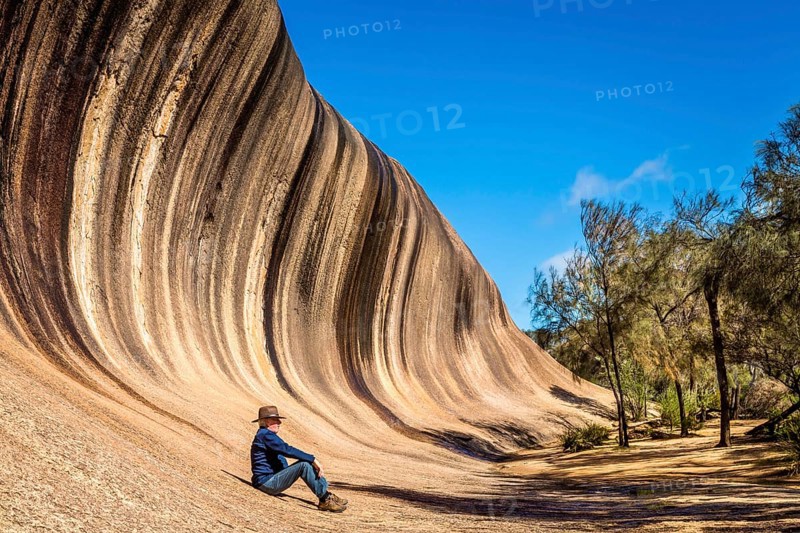 Man resting at the bottom of Wave Rock