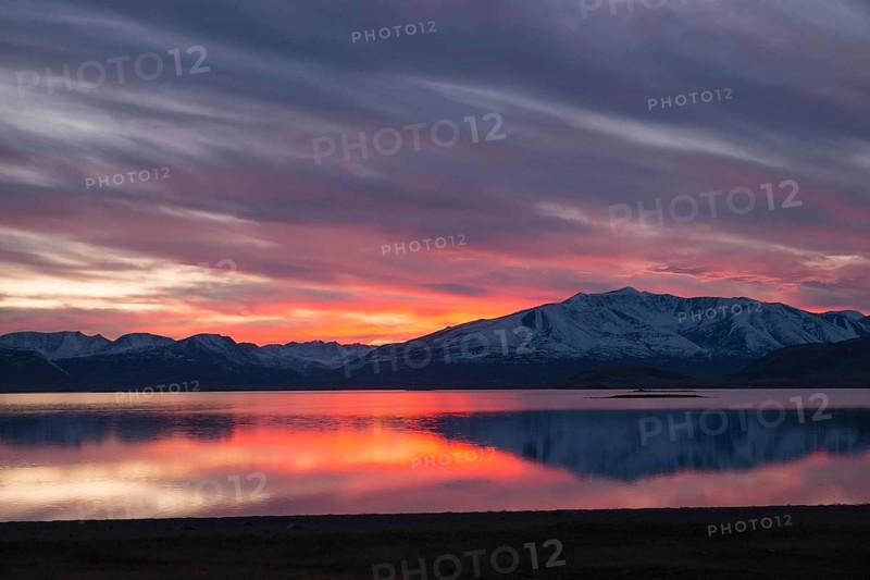 Sunset with an intense coloured sky reflected in Khoton Nuur