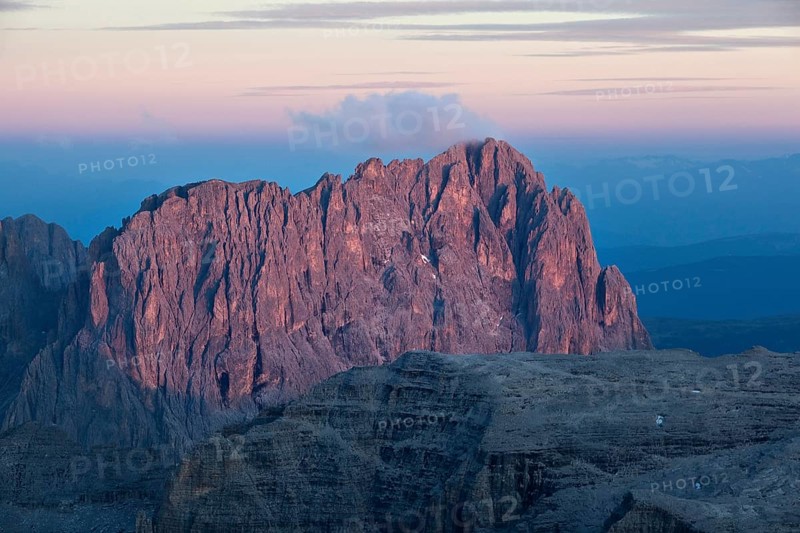 View from Pordoi Pass of mountains Sellastock and Langkofel or Sasso Lungo at dusk