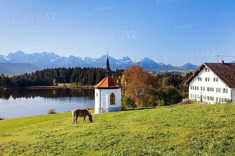Chapel on Lake Hergratsried with Allgau Alps