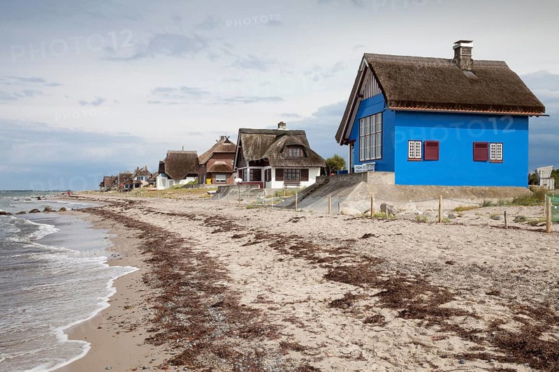 Houses with thatched roofs on the coast