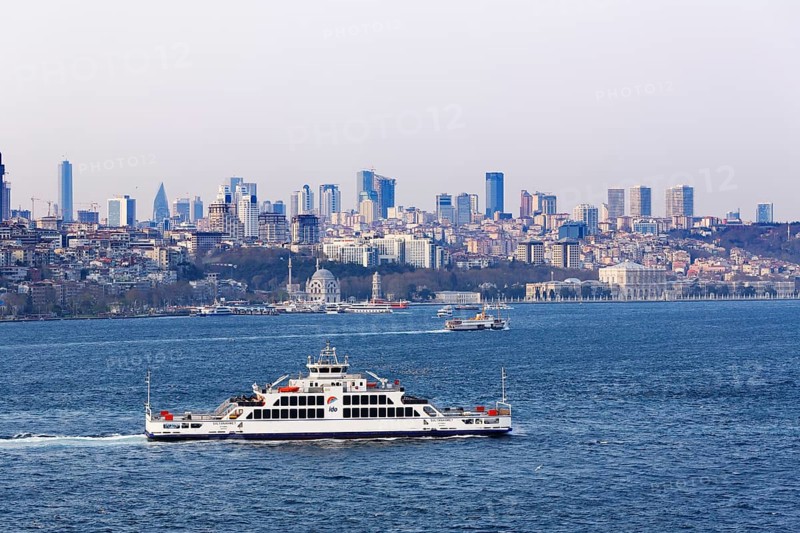 Car ferry on the Bosphorus and the districts of Besiktas and Sisli with Dolmabahce Palace
