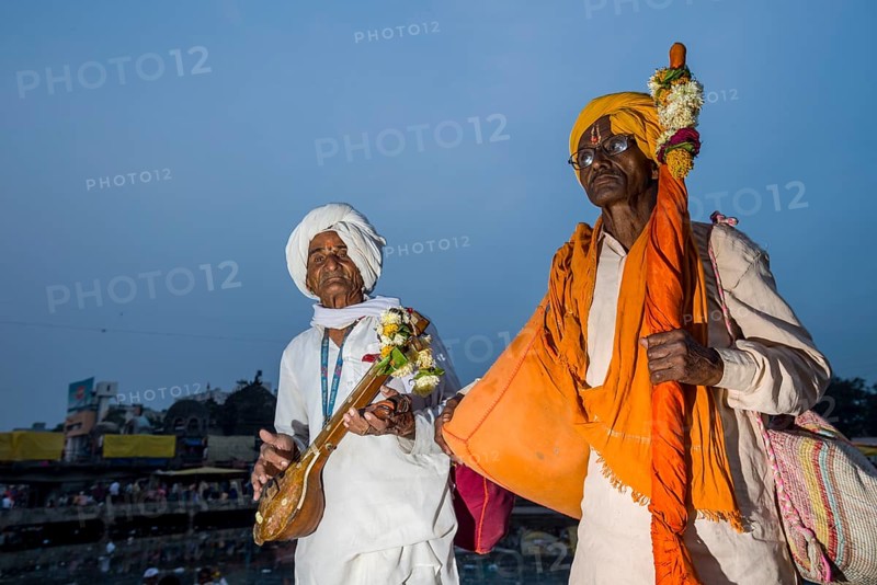 Two devotees with their music instruments at the banks of the holy river Godwari