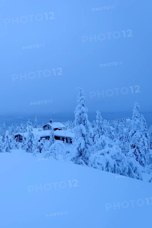 Finnish log cabin in the snow-covered landscape