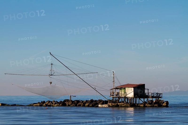 Fisherman's house with a net over the sea in Marina di Pisa