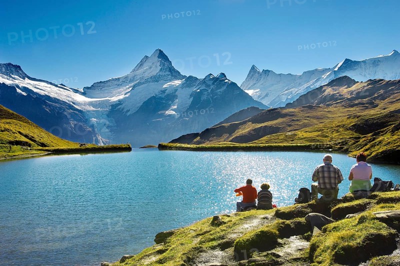 Walkers having a rest next to Bachalpsee lake near Grindelwald First