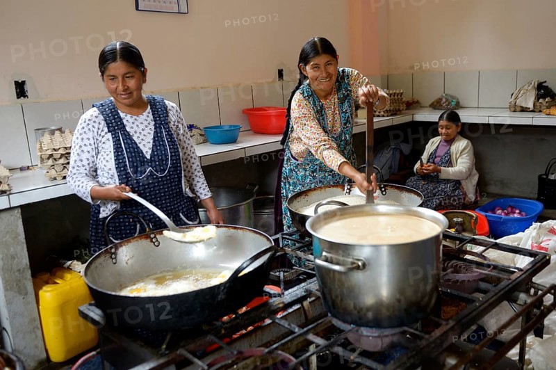 Cooks working in the kitchen of a boarding school