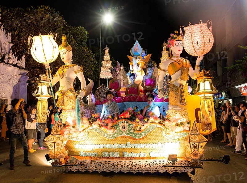 Women in traditional costume travelling on a float
