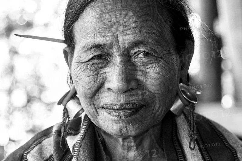 Woman with a traditional facial tattoo and ear jewelry