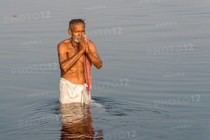Pilgrim taking a bath praying in the holy Yamuna river
