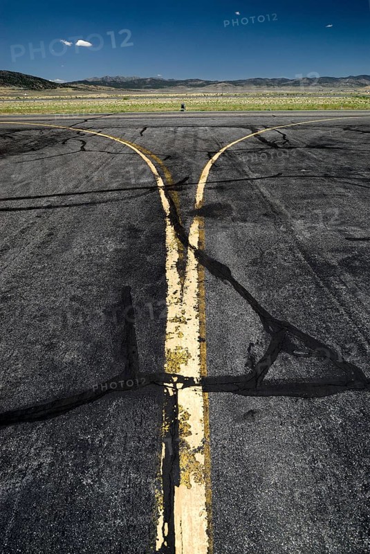 Yellow worn tarmac markings at an airport