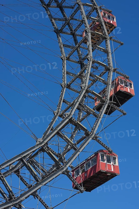 Three cabins of the Wiener Riesenrad ferris wheel against a blue sky at the Prater