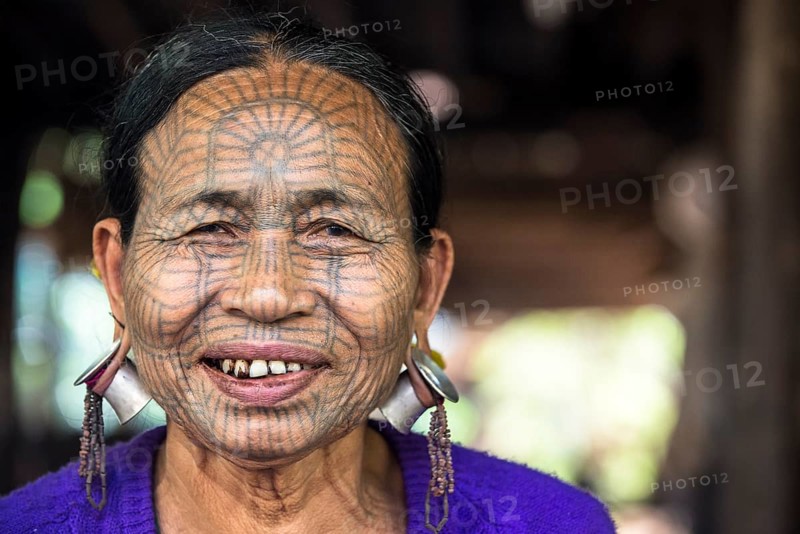 Woman with a traditional facial tattoo and ear jewelry