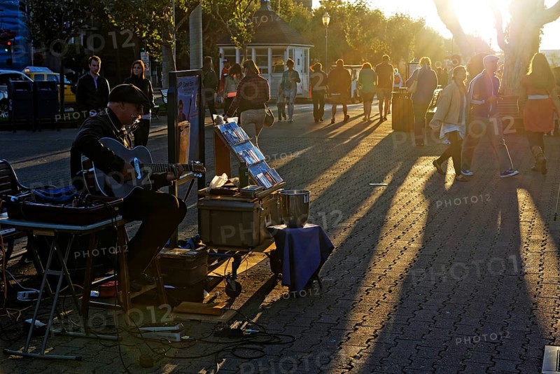 Street musician playing at the Fisherman Wharf in the evening light