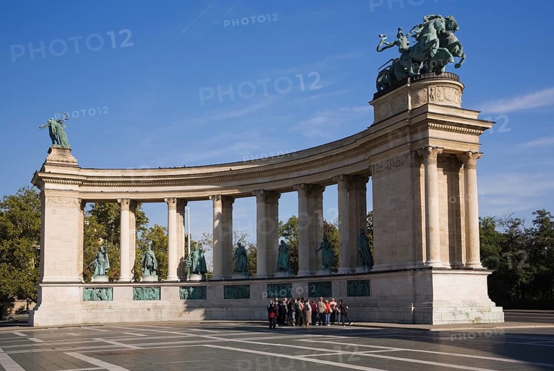 Tourist group standing in front of the colonnade on Hero's Square or Hosok tere