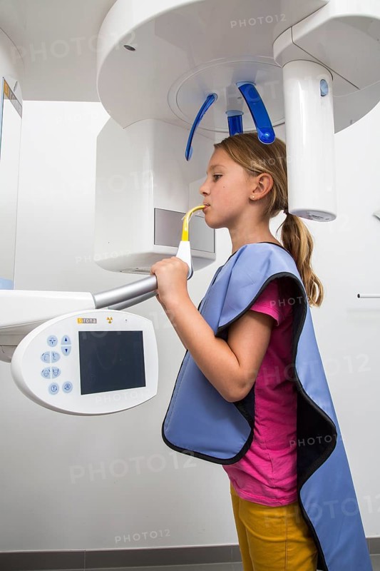 Girl receiving an x-ray of her teeth