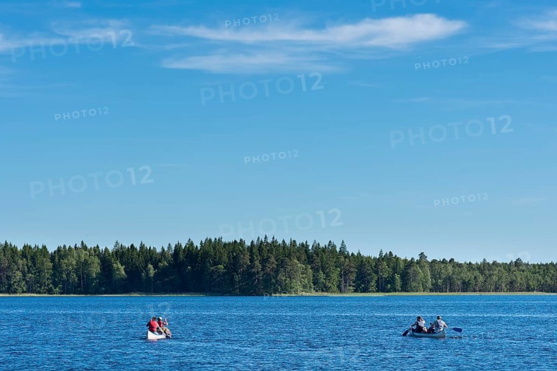 Two canoes with canoeists on Lake Asnen